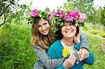 Portrait of mother and daughter wearing wreaths of flowers, Nykoping, Sodermanland, Sweden