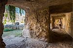 Tourist exploring the tunnels at the Greek ruins, Eurialo Casle (Castello Eurialo), Syracuse (Siracusa), Sicily, Italy, Europe