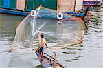 Fisherman casting net along the Mekong River in the capital city of Phnom Penh, Cambodia, Indochina, Southeast Asia, Asia