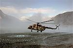 Helicopter landing on heliport in valleys of Karokoram Mountains, Skardu Valley, North Pakistan