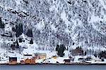 Homes and fishing huts  in hamlet across fjord from Sandneshamnvegen 862 on Kvaloya Island, Tromso, Arctic Circle, Northern Norway