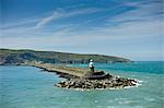 Fishguard Harbour wall and lighthouse with sea defences, Pembrokeshire, Wales, UK