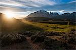 Late sunrays breaking through the clouds before the towers of the Torres del Paine National Park, Patagonia, Chile, South America