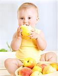 Happy little baby girl eating fresh tasty fruits for lunch, enjoying healthy food at home, organic nutrition for kids