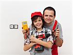 Boy and his father ready for some electricity work - against white wall