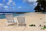 Inviting white chairs on a beach. Barbados
