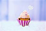 Photo of cute cupcake on wooden background