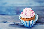 Photo of cute cupcake on wooden background