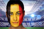 Composite image of beautiful belgian fan in face paint against large football stadium with lights