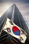 South korea national flag against low angle view of skyscraper