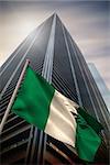 Nigeria national flag against low angle view of skyscraper
