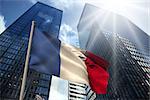 France national flag against low angle view of skyscrapers
