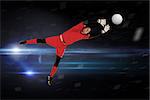 Fit goal keeper jumping up against black background with spark