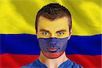 Composite image of serious young colombia fan with facepaint against digitally generated colombia national flag