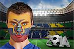 Composite image of serious young ecuador fan with face paint against large football stadium