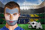 Composite image of serious young argentina fan with face paint against large football stadium with brasilian fans