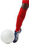 Football player kicking ball with boot on white background