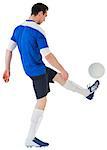 Football player in blue kicking ball on white background