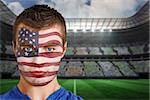 Composite image of usa football fan in face paint against large football stadium under spotlights