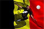 Football player in black kicking against belgium flag