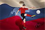 Football player in red kicking against digitally generated russian national flag