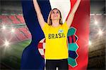 Excited football fan in brasil tshirt holding croatia flag against vast football stadium with fans in yellow and red