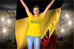Excited football fan in brasil tshirt holding belgium flag against vast football stadium with fans in yellow