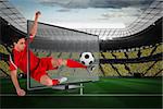 Composite image of fit football player kicking ball through tv against large football stadium with fans in yellow