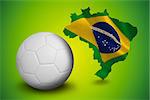 Digitally generated white leather football  against green brazil outline with flag