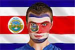 Composite image of serious young football fan in face paint against costa rica national flag