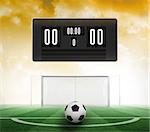 Black scoreboard with no score and football against football pitch under yellow sky