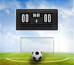 Black scoreboard with no score and football against football pitch under blue sky