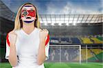 Excited costa rica fan in face paint cheering against football pitch in large stadium