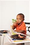 Boy Eating Lunch at Kitchen Table