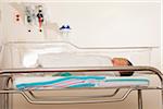 Close-up of newborn baby in hospital neonatal bassinet, Maryland, USA