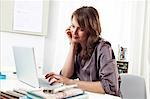 Woman works in office, using laptop, Munich, Bavaria, Germany