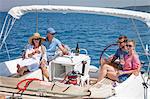 Two couples on sailboat, drinking champagne, Adriatic Sea, Croatia