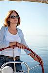 Mature woman on sailboat, steering, Adriatic Sea, Croatia