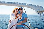 Mature couple sailing together, taking pictures, Adriatic Sea, Croatia