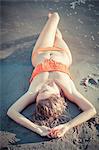 Young woman in bikini relaxing on beach, Drava river, Osijek, Croatia