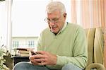 Senior man using phone in nursing home, Bavaria, Germany