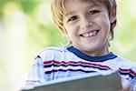 Boy holding digital tablet