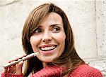 Woman smoking electronic cigarette, smiling