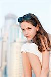 Preteen girl sitting outdoors, portrait