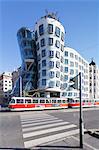 Tram in front of the Dancing House (Ginger and Fred) by Frank Gehry, Prague, Bohemia, Czech Republic, Europe