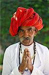 Traditional Namaste greeting from Indian man with traditional Rajasthani turban in village in Rajasthan, India