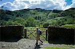 Tourist walking on nature trail in lakeland countryside at Easedale in the Lake District National Park, Cumbria, UK