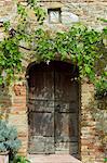 Ancient doorway and religious painting at Il Rigo agritourismo hotel and farmhouse, San Quirico d'Orcia, in Val D'Orcia area Tuscany, Italy