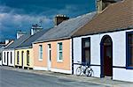 Street scene  pastel painted terraced bungalows and bicycle in Railway Road, Kilkee, County Clare, West of Ireland