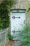 Lavender bush and traditional cottage entrance in the Cotswolds village of Bledington, Oxfordshire, UK